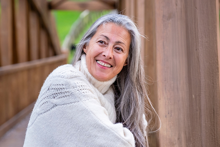 Smiling woman wearing a white sweater