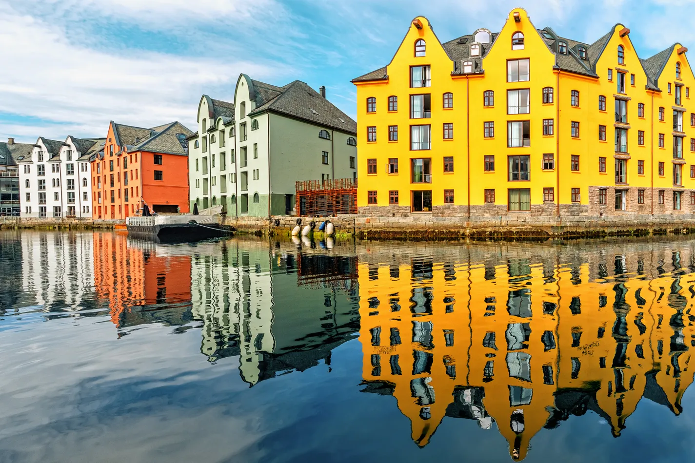 Yellow, green, orange and white buildings along the water's edge