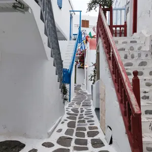 A narrow street with staircases on either side