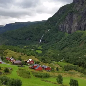 Red houses scattered around a lush, green valley