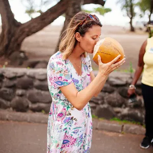 Woman drinking juice from a coconut
